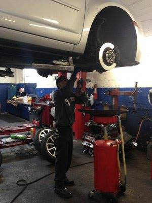 auto work maintenance elevated person standing under
